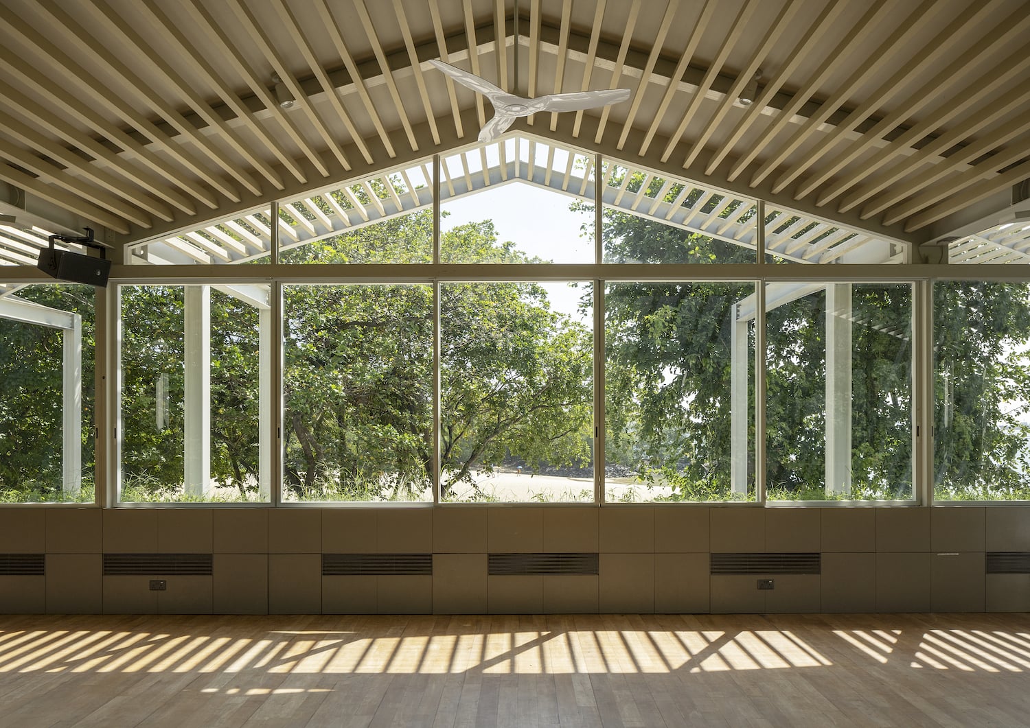 White ceiling fan installed in a contemporary commercial building lobby