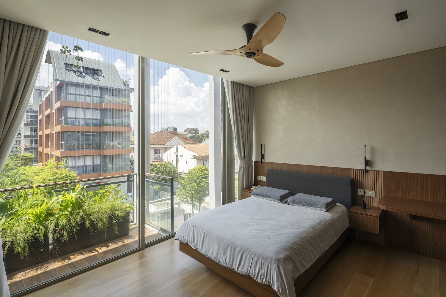Ceiling fan with wood finish installed in a modern residential bedroom