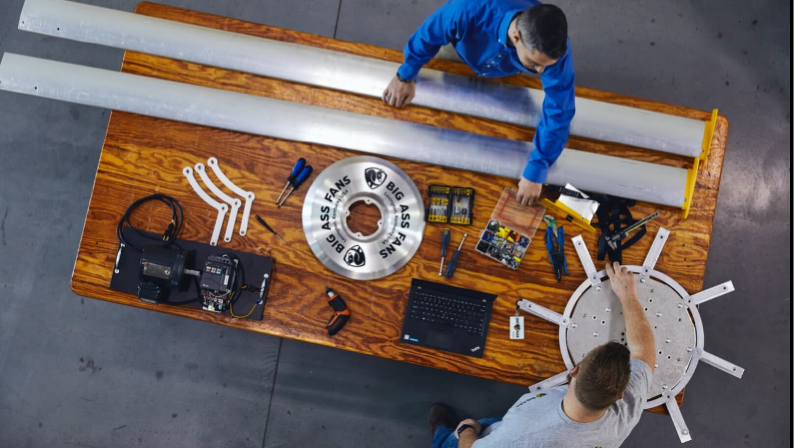 Big Ass Fans employees assembling a large industrial fan at a workbench