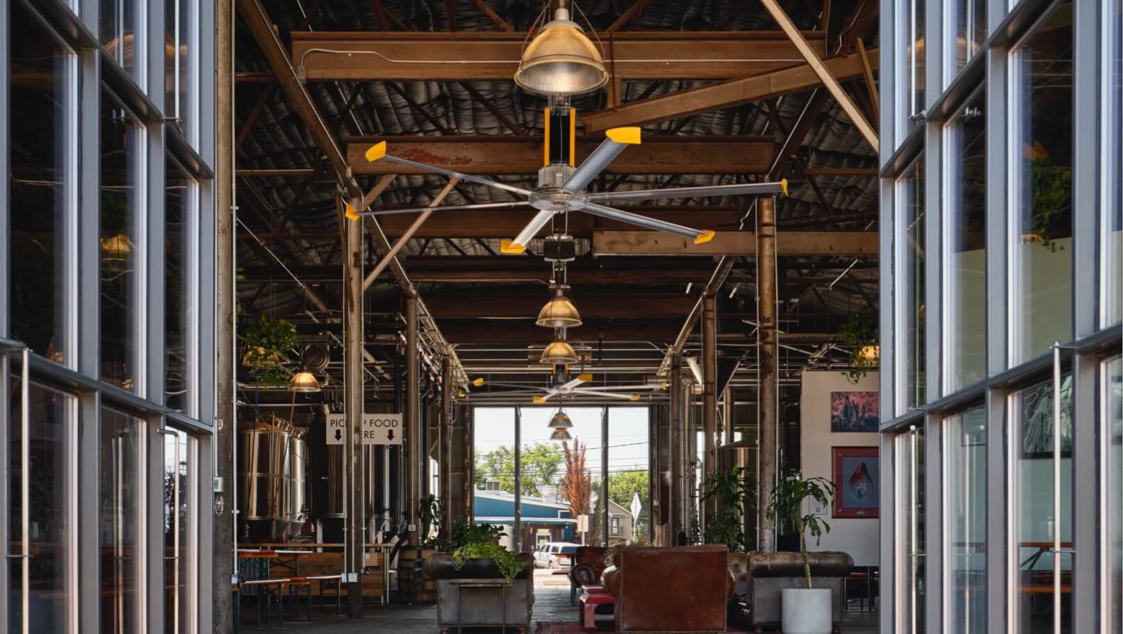 Large industrial ceiling fans installed in a spacious building